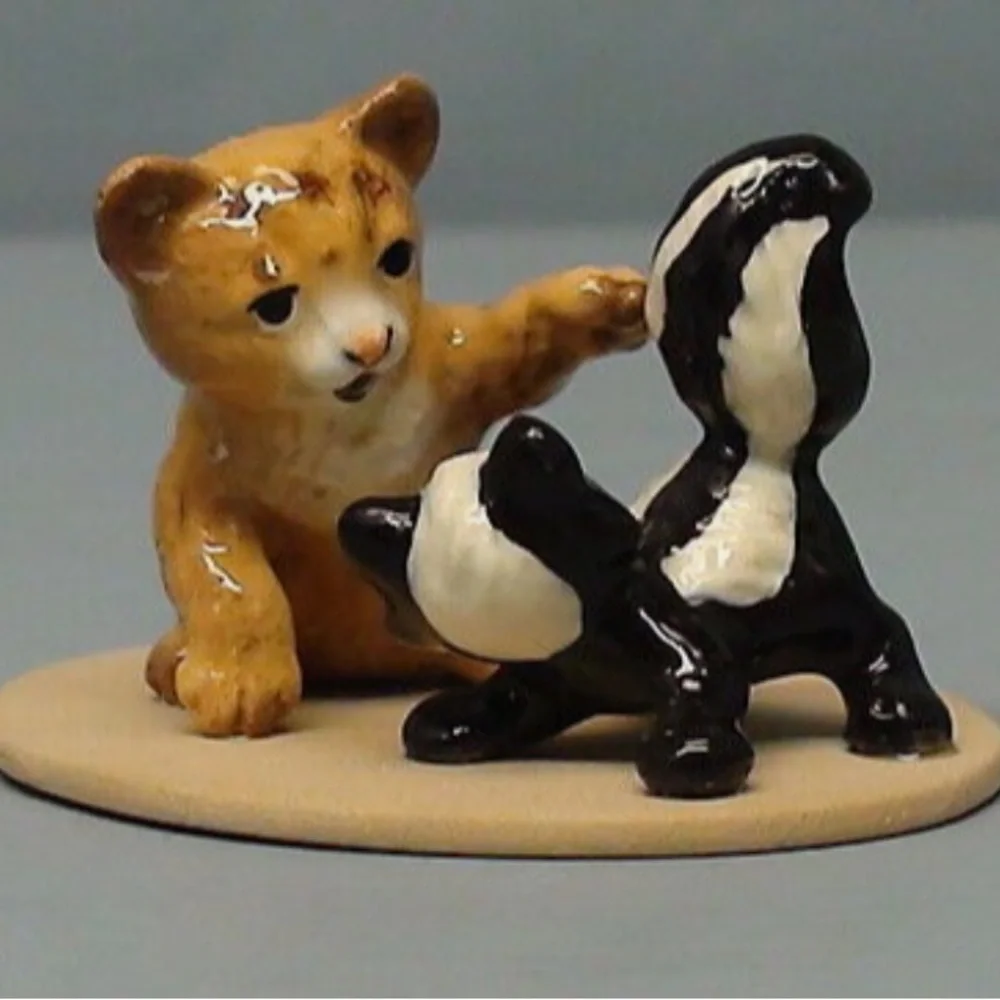 Vintage retired Hagen Renaker bobcat and skunk babies on base